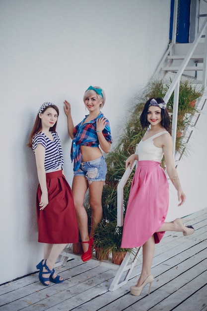 Young girls posing on stairs with plants