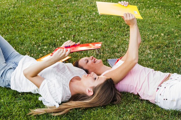 Young girls posing with notepads