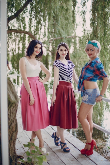 Young girls posing with a tree in the background