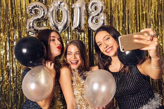 Young girls taking selfie on new year party