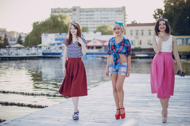 Free photo young girls walking along a promenade