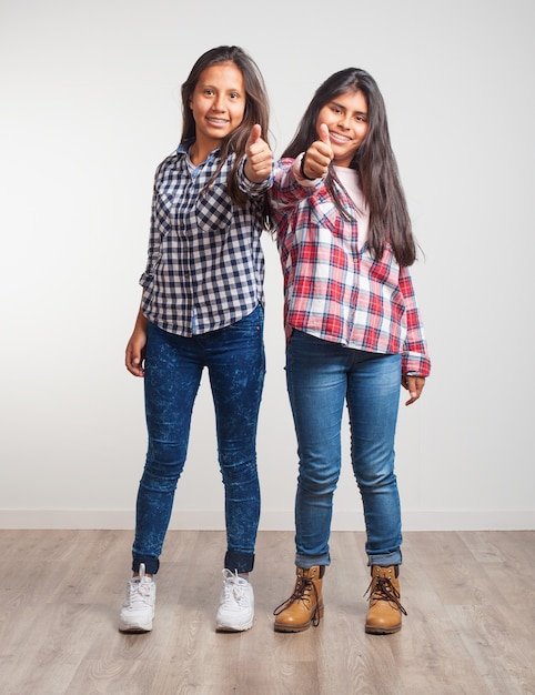 Young girls with thumbs up