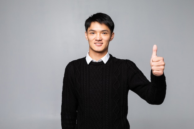 Young good looking man standing wearing on White wall.