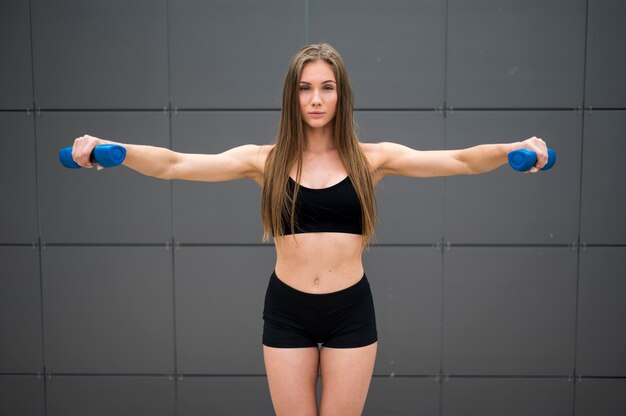 Free photo young gorgeous woman doing sport exercises