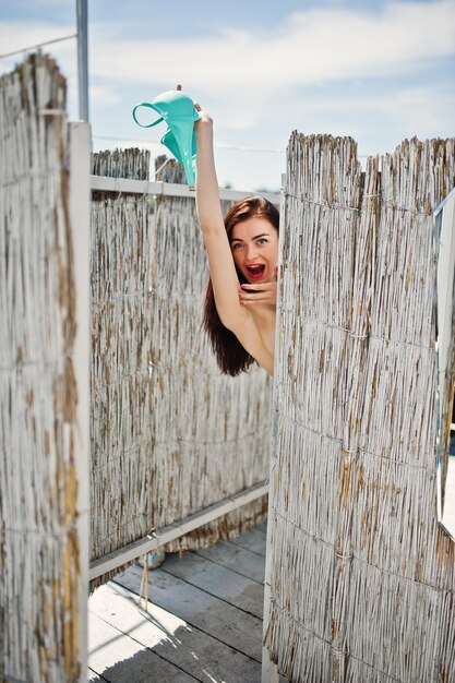 Young gorgeous woman having fun in the changing room by the lake