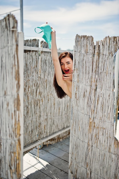 Young gorgeous woman having fun in the changing room by the lake