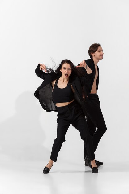 Young and graceful ballet dancers in minimal black style isolated on white