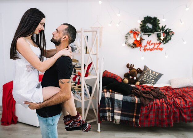 Young guy holding attractive lady