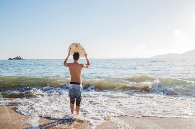 Young guy is going to surf