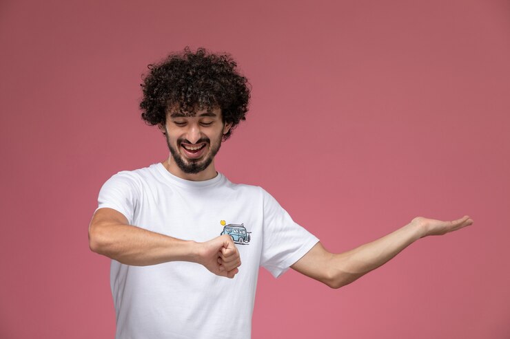 Free Photo young guy laughing at his wrist
