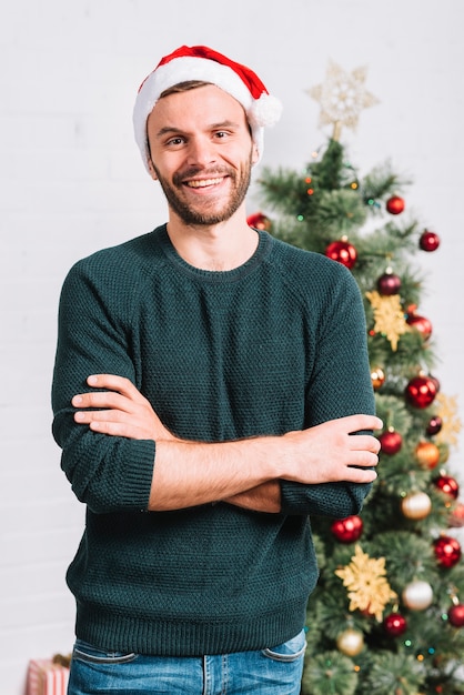 Free photo young guy near christmas tree