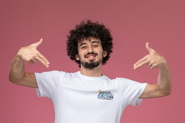 young guy pointing out his new t-shirt