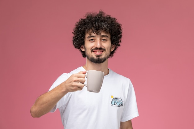 Free photo young guy showing his new cup