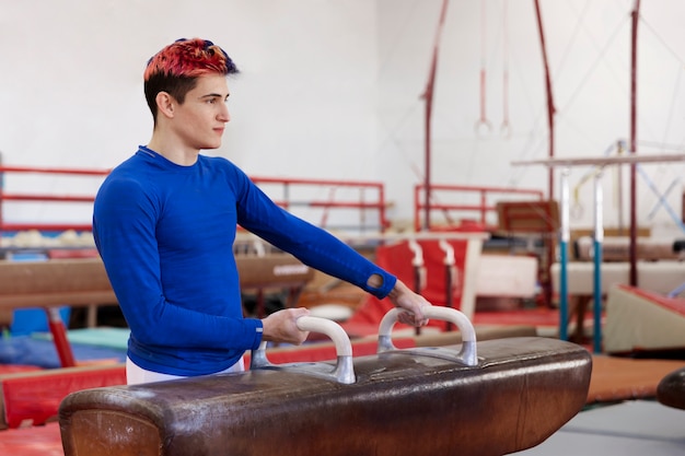 Free photo young gymnast training for competition