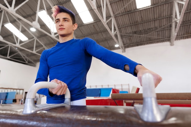 Free photo young gymnast training for competition