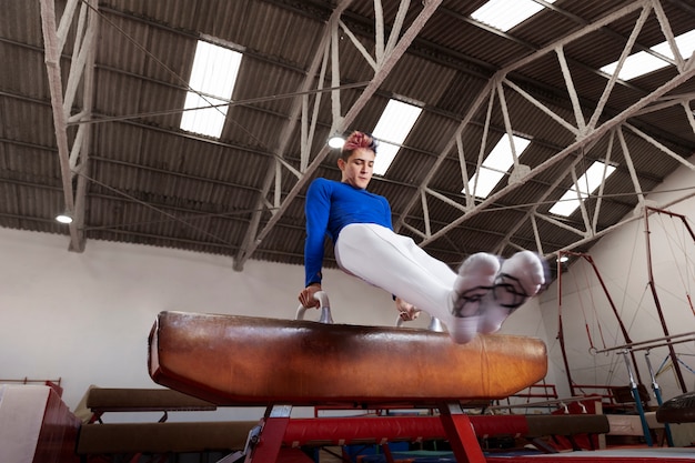 Free photo young gymnast training for competition