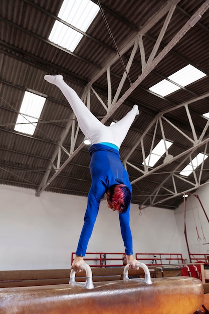 Free photo young gymnast training for competition