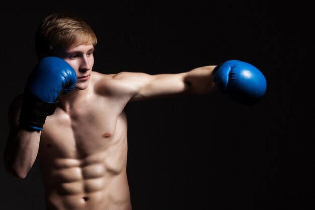 Young handsome boxer in a movement