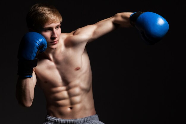 Young handsome boxer in a movement