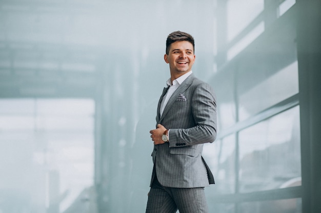 Free photo young handsome business man choosing a car in a car showroom