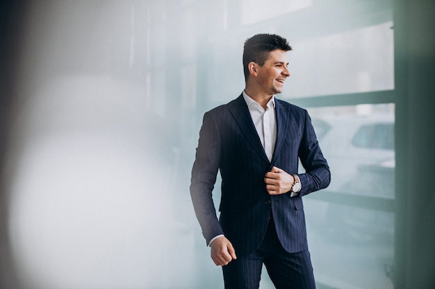 Young handsome business man in a suit in an office