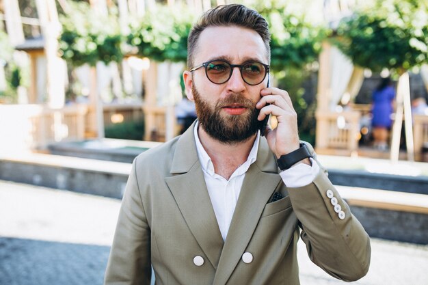 Young handsome business man using phone