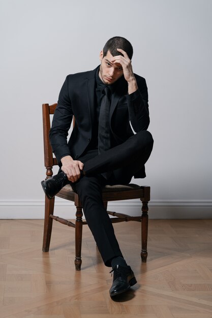 Young handsome businessman in black shirt and black suit