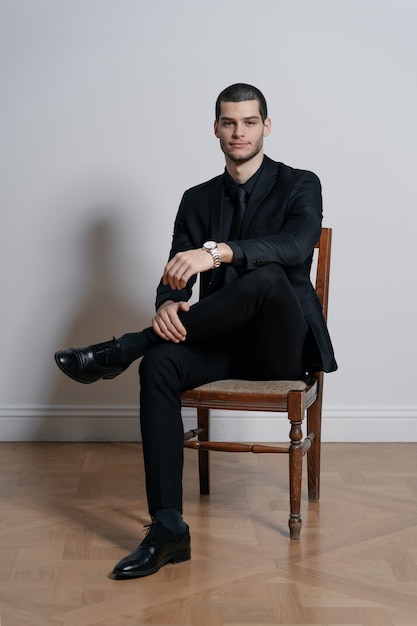 Young handsome businessman in black shirt and black suit