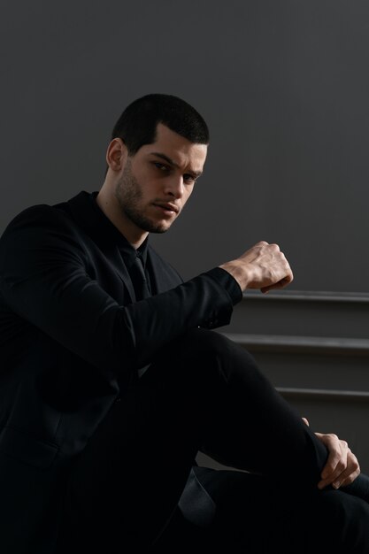 Young handsome businessman in black shirt and black suit