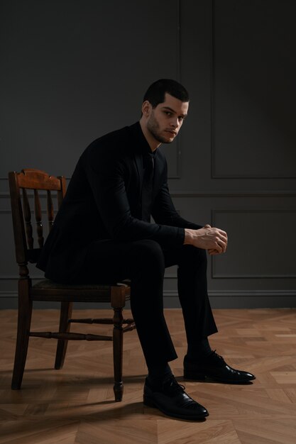 Young handsome businessman in black shirt and black suit