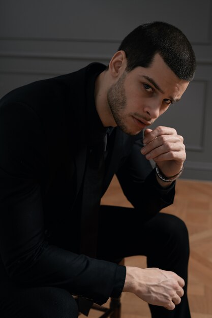 Young handsome businessman in black shirt and black suit