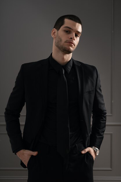 Young handsome businessman in black shirt and black suit