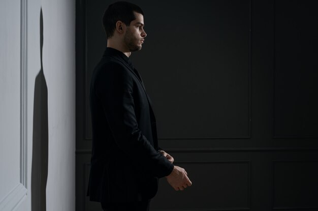 Young handsome businessman in black shirt and black suit