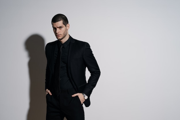 Young handsome businessman in black shirt and black suit