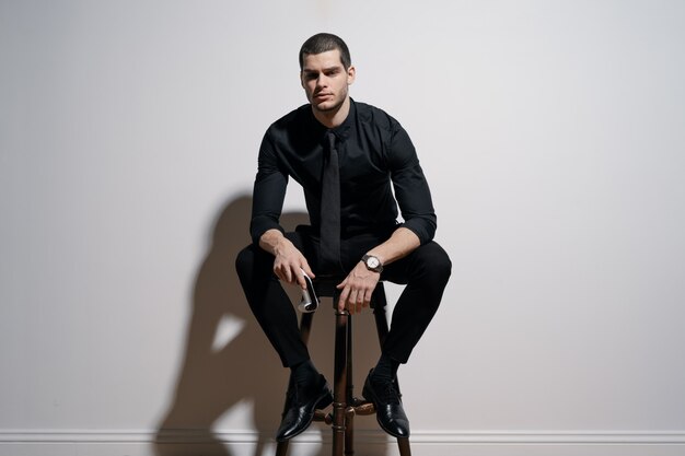 Young handsome businessman in black shirt and black suit