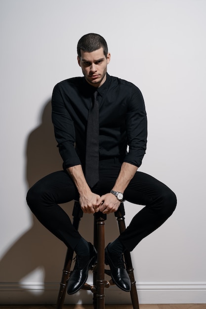 Young handsome businessman in black shirt and black suit