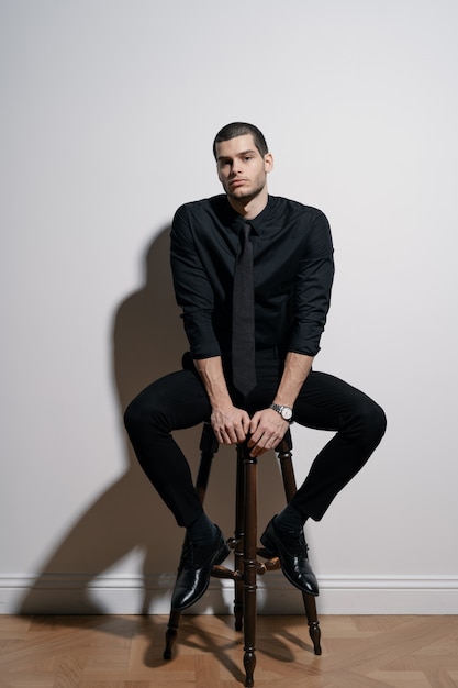 Young handsome businessman in black shirt and black suit