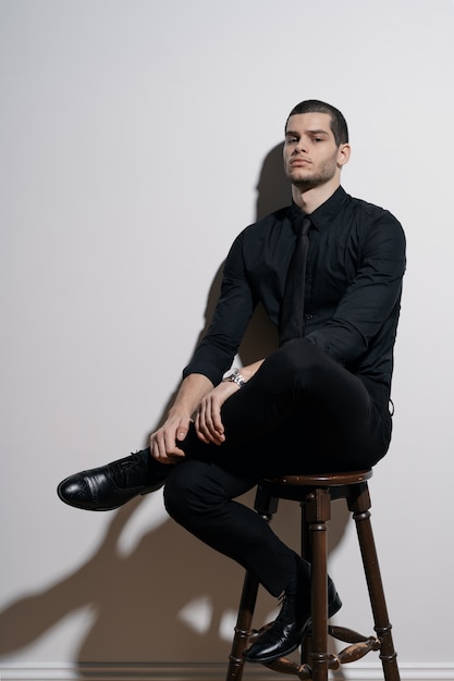 Young handsome businessman in black shirt and black suit