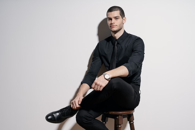 Young handsome businessman in black shirt and black suit