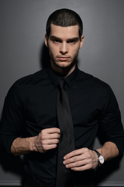 Young handsome businessman in black shirt