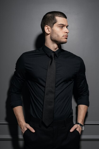 Young handsome businessman in black shirt