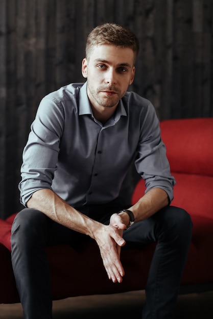 Young handsome businessman posing indoor