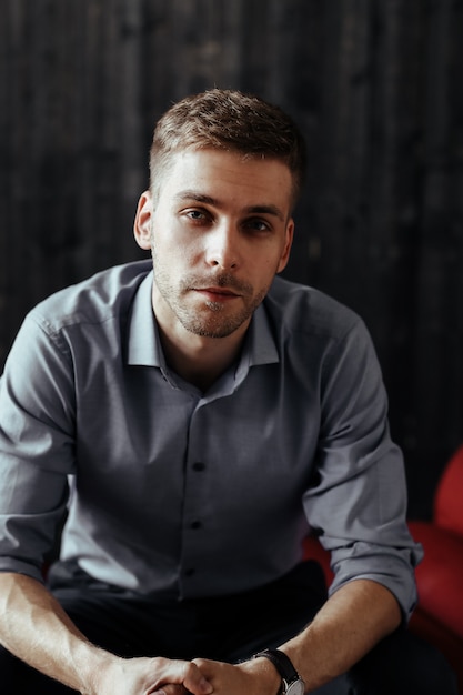 Free photo young handsome businessman posing indoor