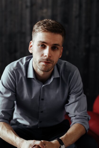 Young handsome businessman posing indoor