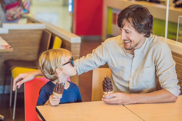 젊고 잘생긴 아버지와 아이스크림을 즐기는 어린 아기