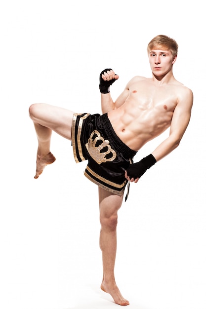 Free photo young handsome fighter in shorts