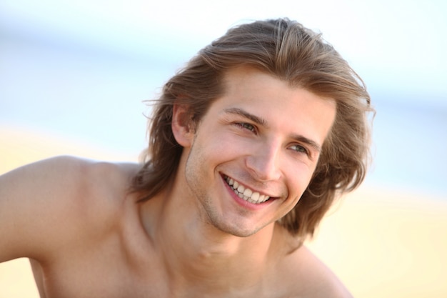 Young and handsome guy on the beach