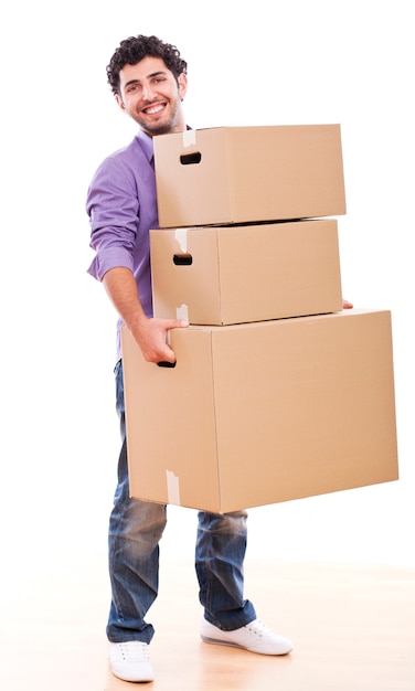 Young and handsome guy carrying boxes