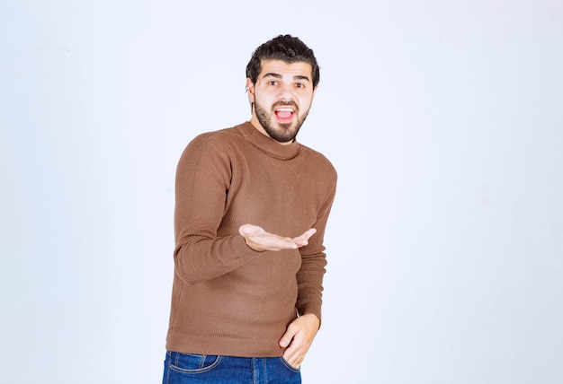 young handsome guy model showing his opened palm.