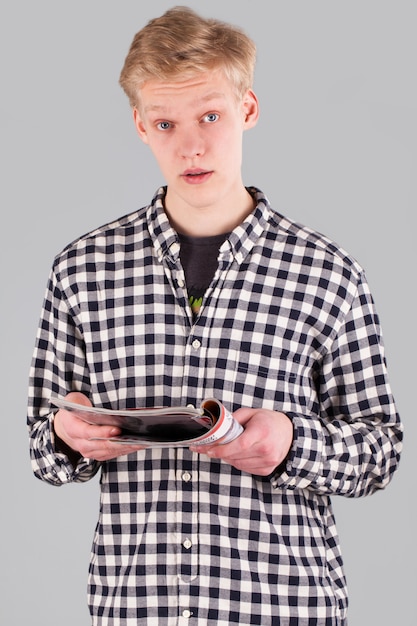 Young handsome guy with journal